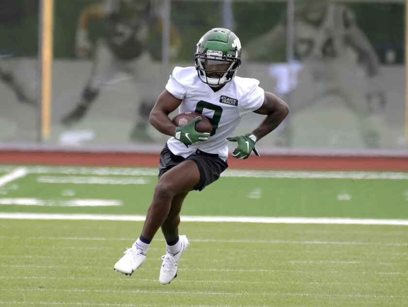FILE - In this Friday, May 7, 2021, file photo, New York Jets second-round draft pick Elijah Moore works out during NFL football rookie camp, in Florham Park, N.J. The Jets signed wide receiver Moore to a four-year deal late Wednesday, July 21, 2021. (AP Photo/Bill Kostroun, File)
