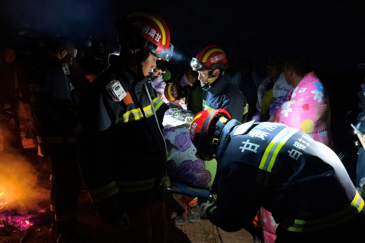 A nighttime photograph of rescuers assisting runners. 