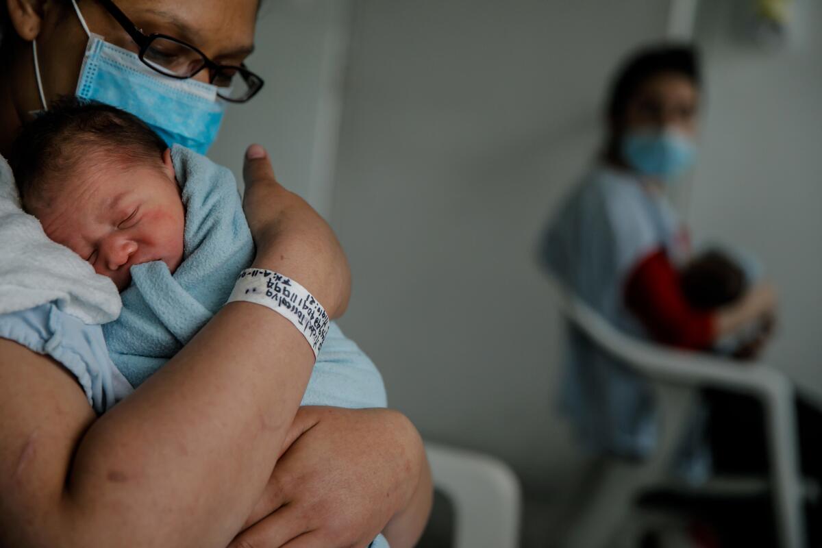Belys Torrealba Tovar, 24, cuddles her newborn, Angel, at the Hospital Materno Infantil in Bogota, Colombia. The hospital sees more than a dozen births each day, roughly a third of them to Venezuelan mothers such as Torrealba.