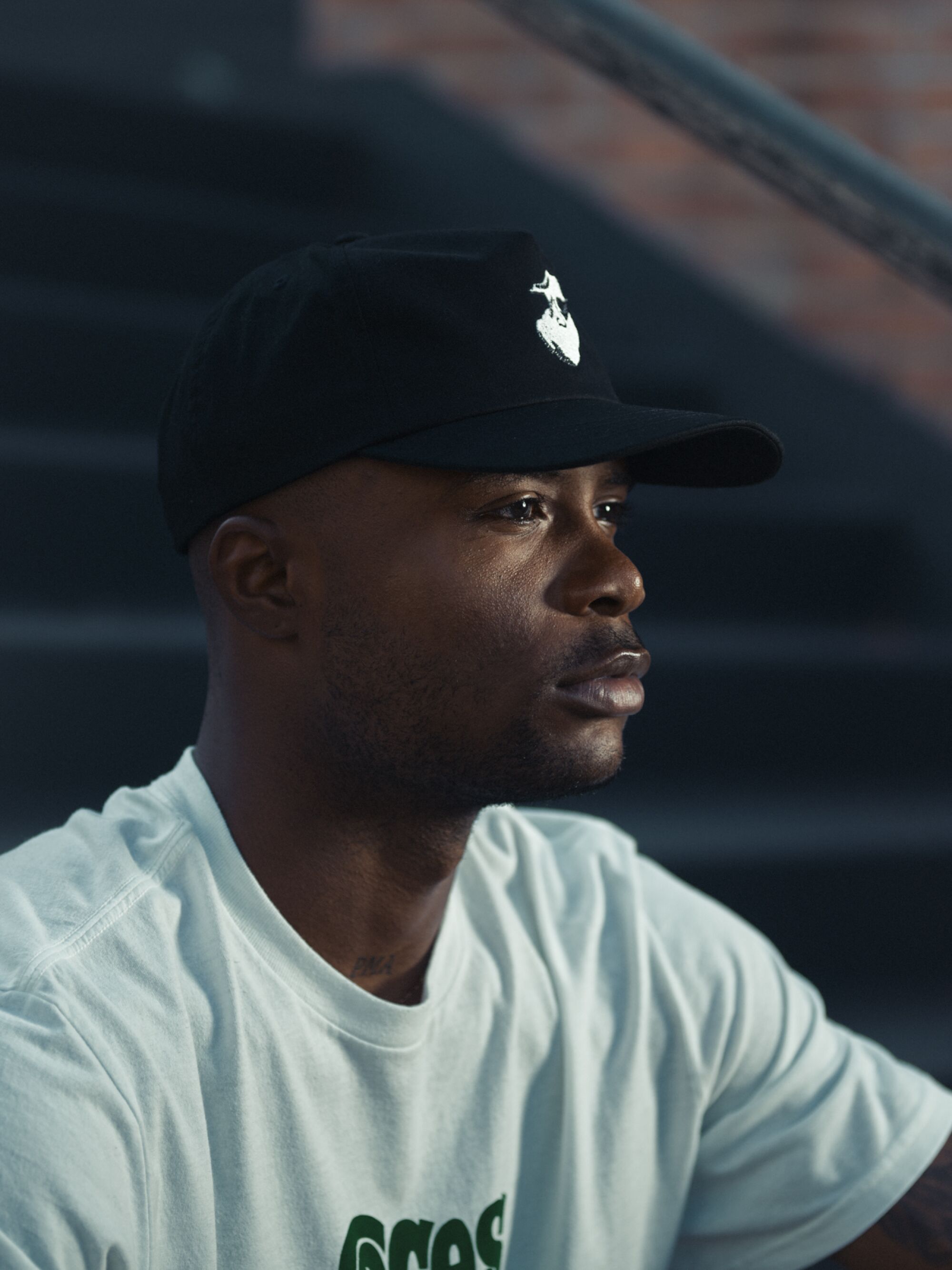 Portrait of skater Dashawn Jordan sitting on a staircase.