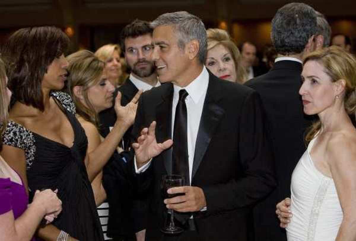 George Clooney, center, chats with other guests as they attend the 2012 White House Correspondents' Dinner.