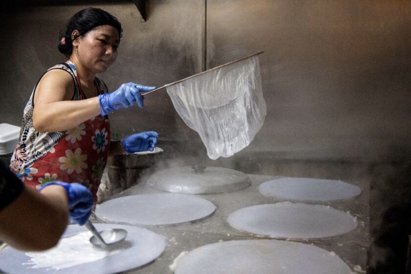 GARDEN GROVE, CA-June 7, 2019: Employees make rice sheets inside Bahn Cuon Luu Luyen on Friday, June 7, 2019. (Mariah Tauger / Los Angeles Times)