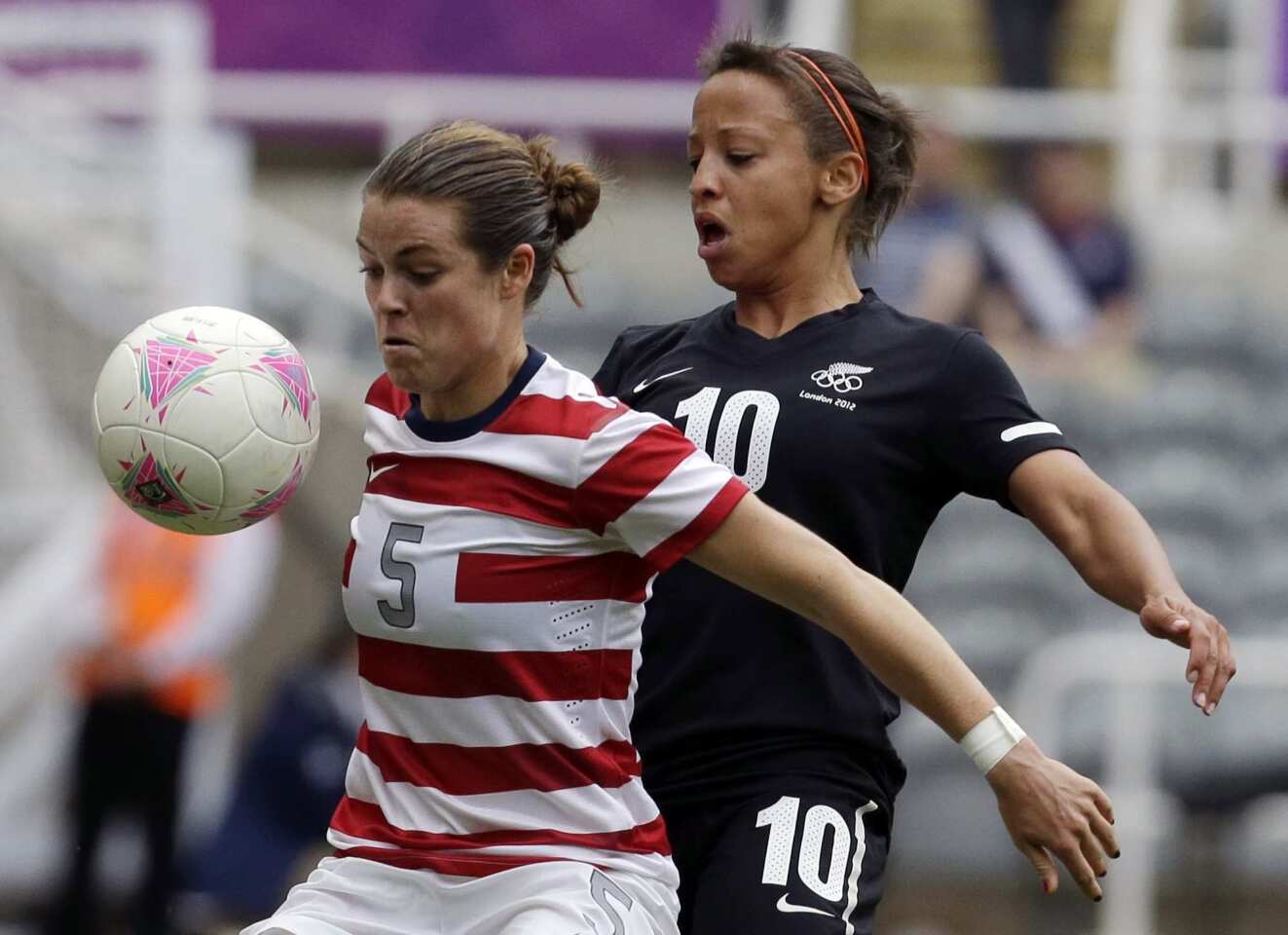 Kelley O'Hara, left, of the U.S. fights for the ball with New Zealand's Sarah Gregorius during their quarterfinal soccer match at the St. James' Park in Newcastle.