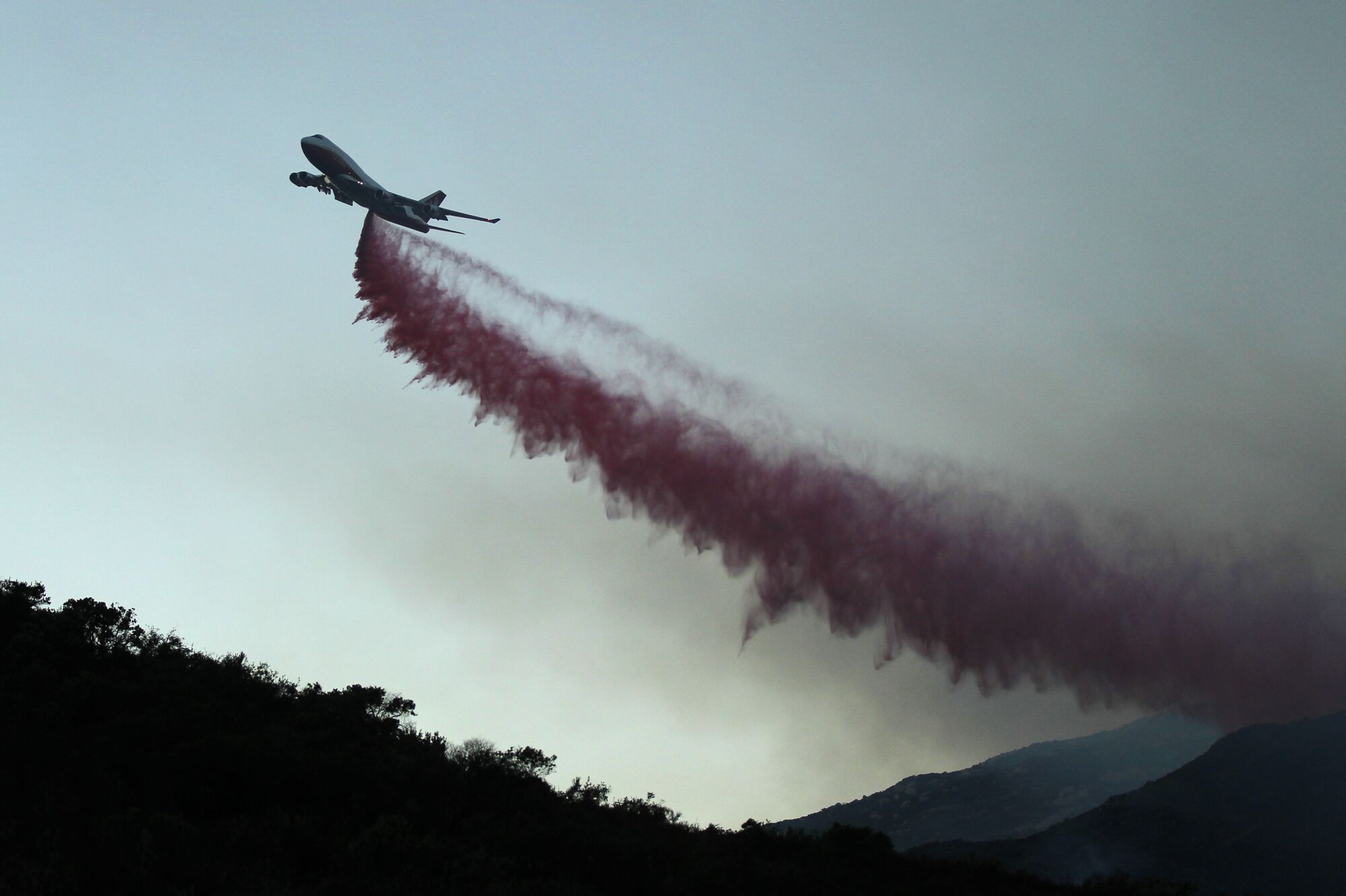 A 747 tanker drops fire retardant along Lyons Valley Road during the Valley Fire on Sunday, Sept. 6, 2020.