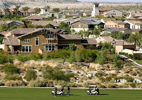 Golfers enjoy a sunny day backdropped by houses in the Veraddo development 25 miles west of Phoenix. The Phoenix metropolitan area is a magnet for people from the Golden State for two reasons: good real estate prices and jobs.
