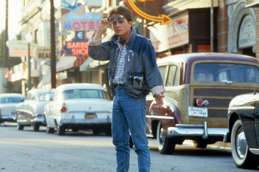 Michael J Fox walkS across the street in a scene from the film "Back To The Future," 1985.