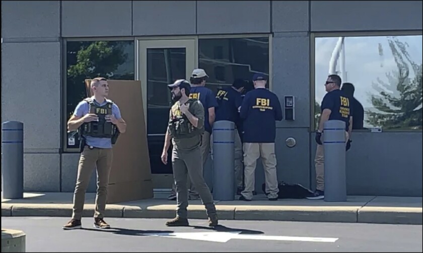 Officials gather outside the FBI building in Cincinnati on Aug. 11