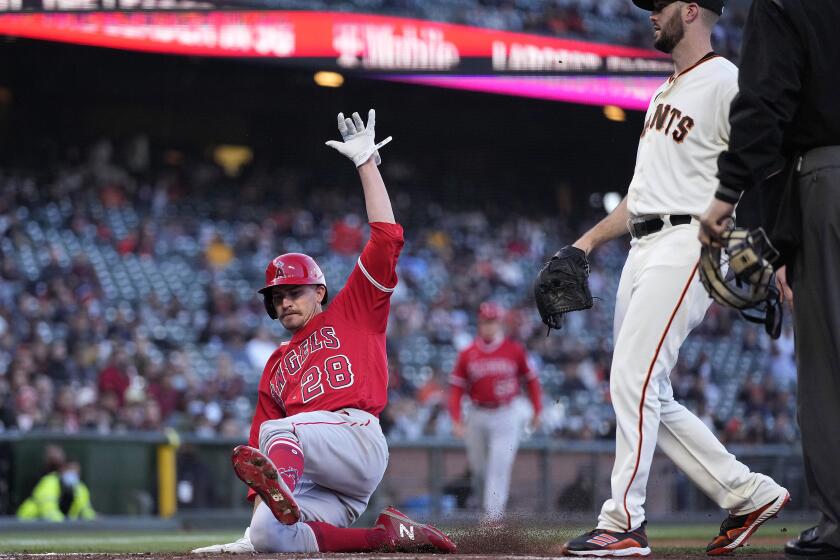 Los Angeles Angels' Andrew Heaney (28) scores on a wild pitch by San Francisco Giants pitcher Alex Wood, right, during the third inning of a baseball game Tuesday, June 1, 2021, in San Francisco. (AP Photo/Tony Avelar)