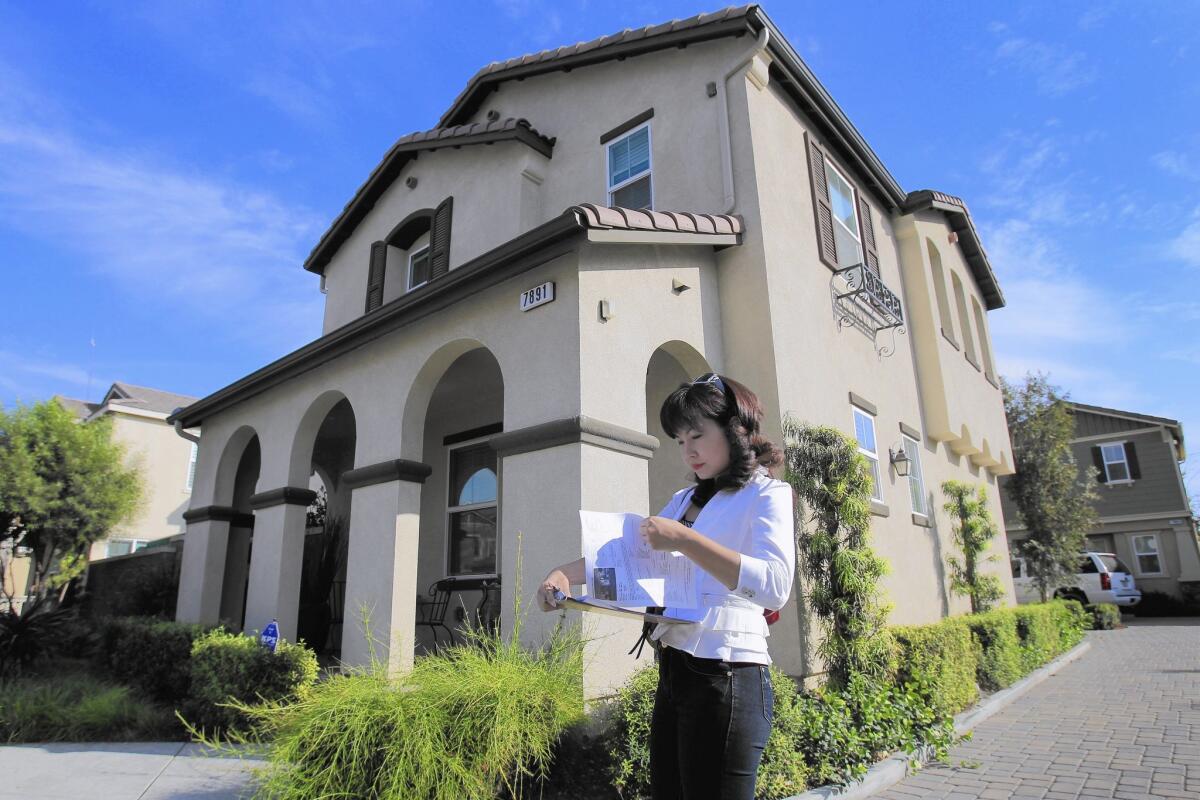 Alisha Chen's job requires being part cultural ambassador, part property scout, part monetary policy wonk. Above, she checks out a home for sale in Chino.