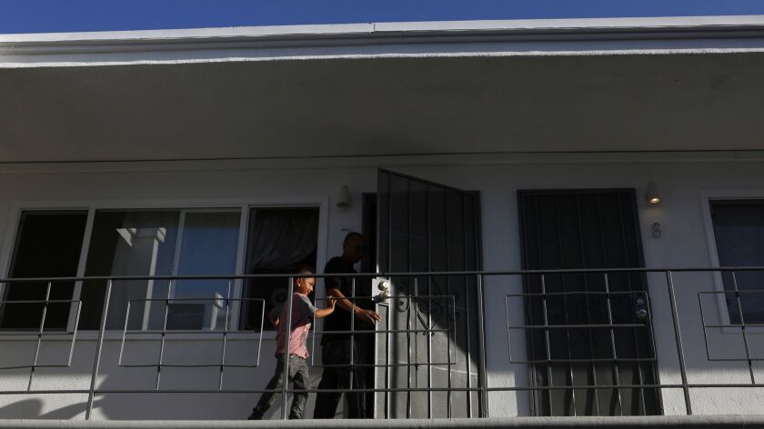 Renters walk into their apartment in Long Beach, Calif. on June 15, 2018. Tenants in this building have since been evicted so that units could be remodeled and rented for a higher amount.