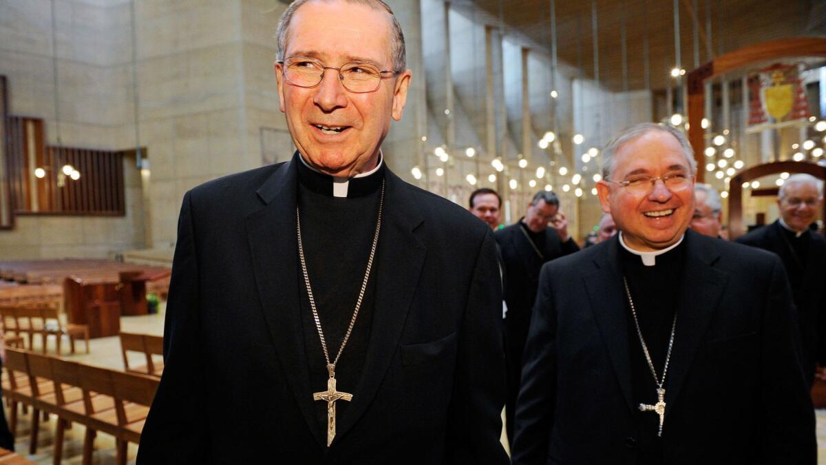 Cardinal Roger Mahony, left, walks with his successor, Archbishop Jose Gomez, at the Cathedral of Our Lady of the Angels in this 2010 file photo.