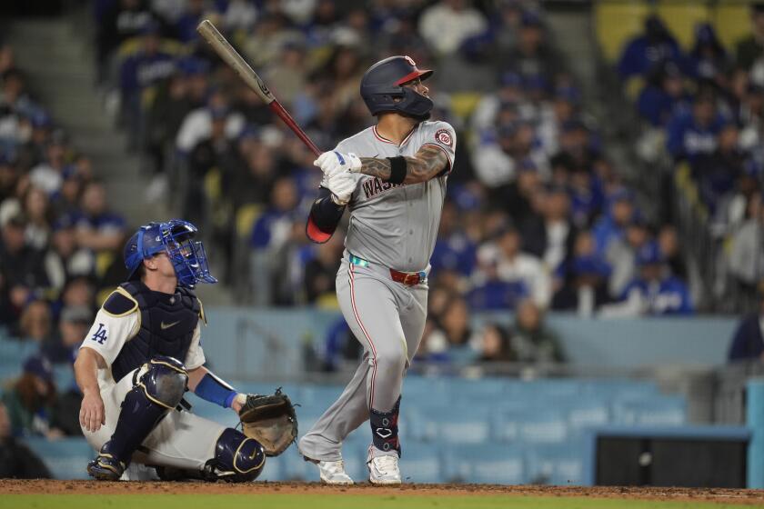 Washington Nationals' Luis Garcia Jr., right, follows through on his three-run home run during the fifth inning of a baseball game against the Los Angeles Dodgers, Monday, April 15, 2024, in Los Angeles. (AP Photo/Marcio Jose Sanchez)