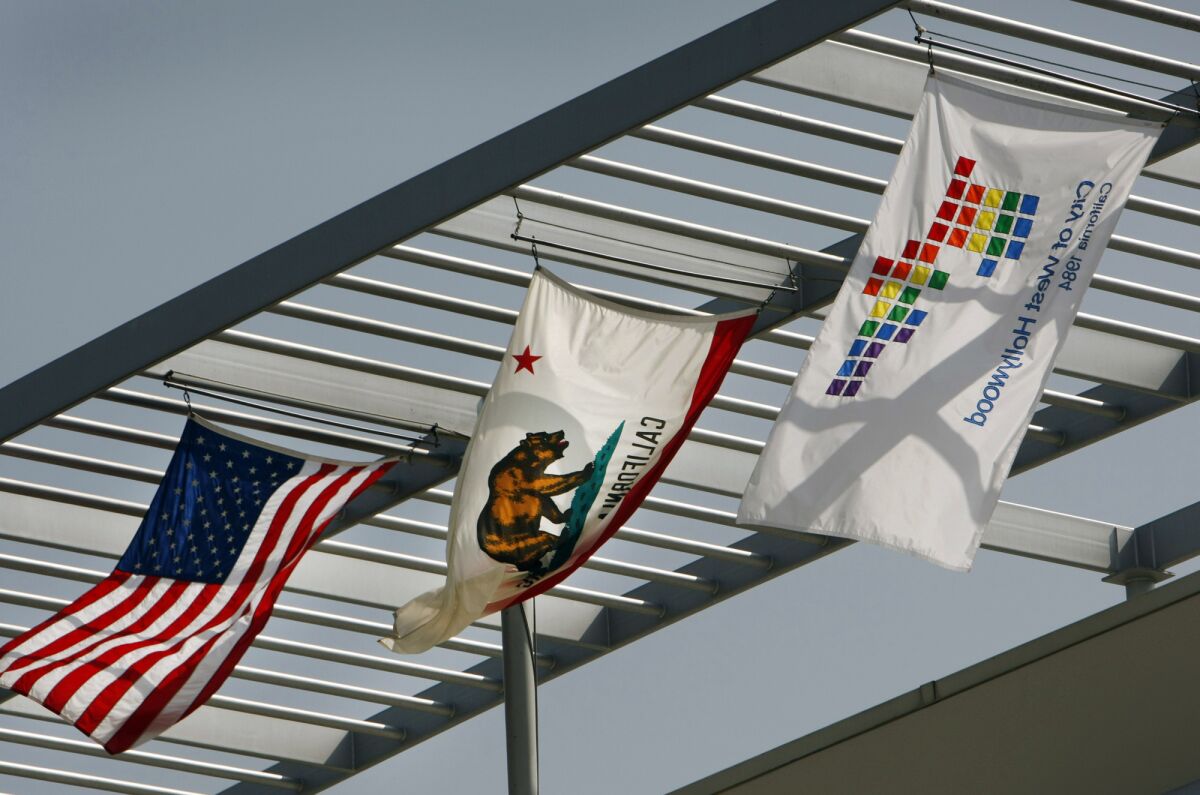 The logo flag flies over the rooftop of the West Hollywood City Hall located on Santa Monica Boulevard in West Hollywood.