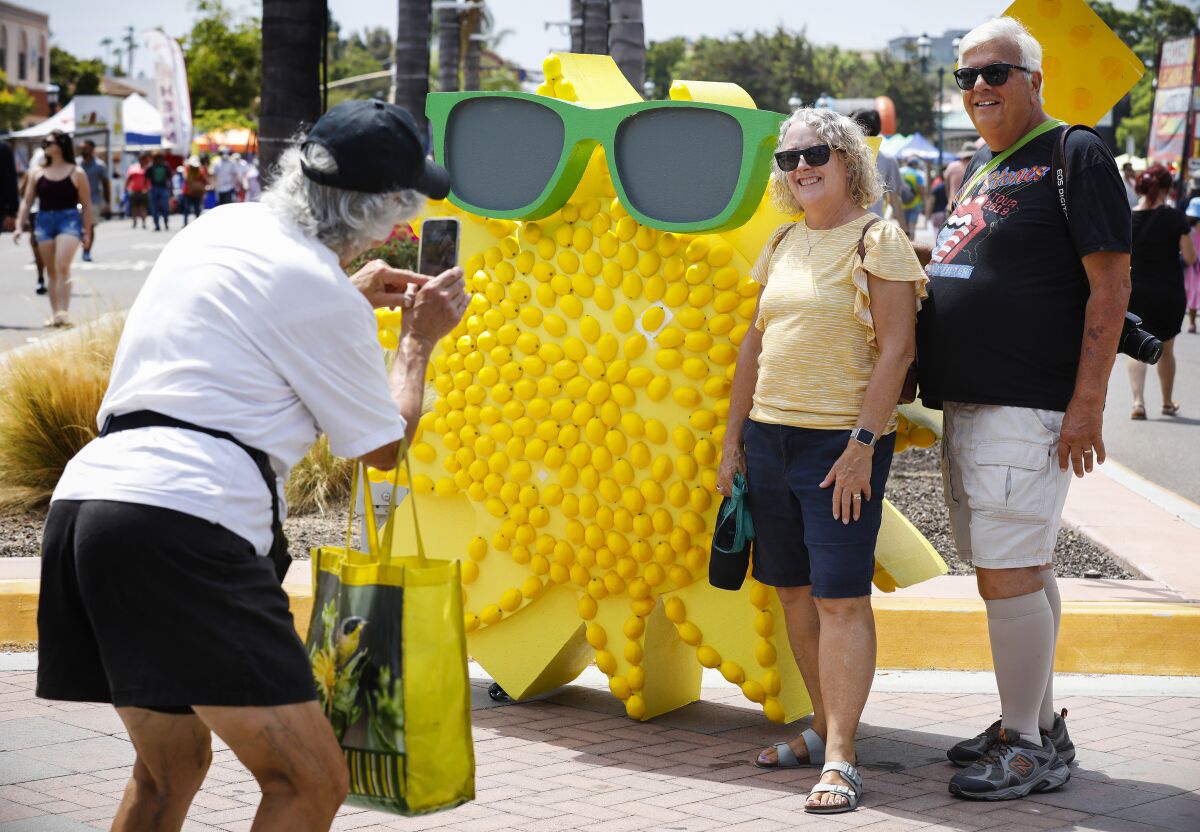 Marion Brandt takes a photo of Teri (center) and Mike Gardner (right) by one of many lemon-themed displays.