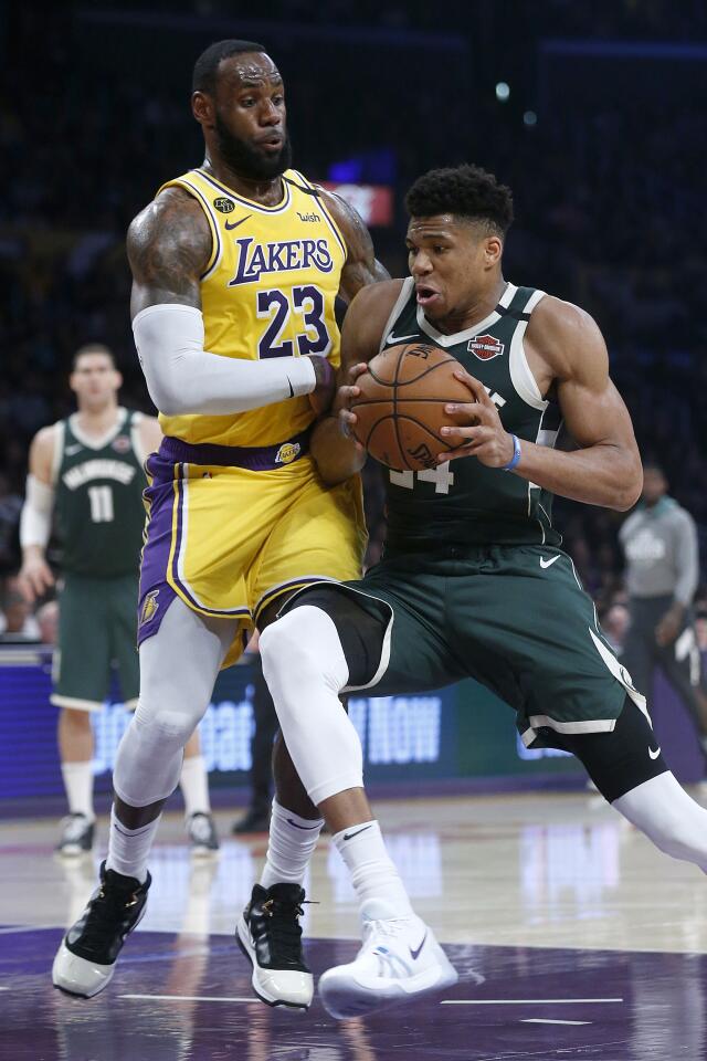 LOS ANGELES, CALIF. -- FRIDAY, MARCH 6, 2020: Los Angeles Lakers forward LeBron James (23) guards Milwaukee Bucks forward Giannis Antetokounmpo (34) causing him to lose possession of the ball to the Los Angeles Lakers in the first half at the Staples Center in Los Angeles, Calif., on March 6, 2020. (Gary Coronado / Los Angeles Times)