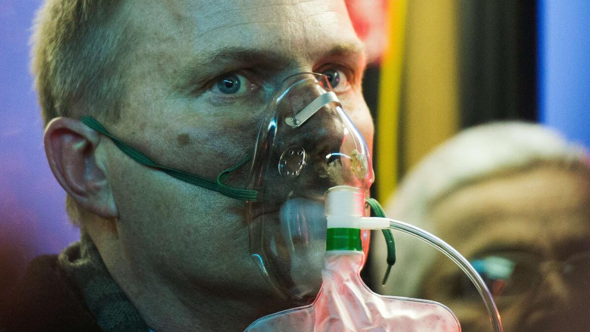 A man receives oxygen after smoke filled the L'Enfant Plaza subway station in Washington.