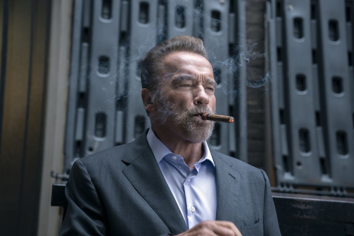 Arnold Schwarzenegger as Luke Brunner, who is smoking a cigar, in "FUBAR."