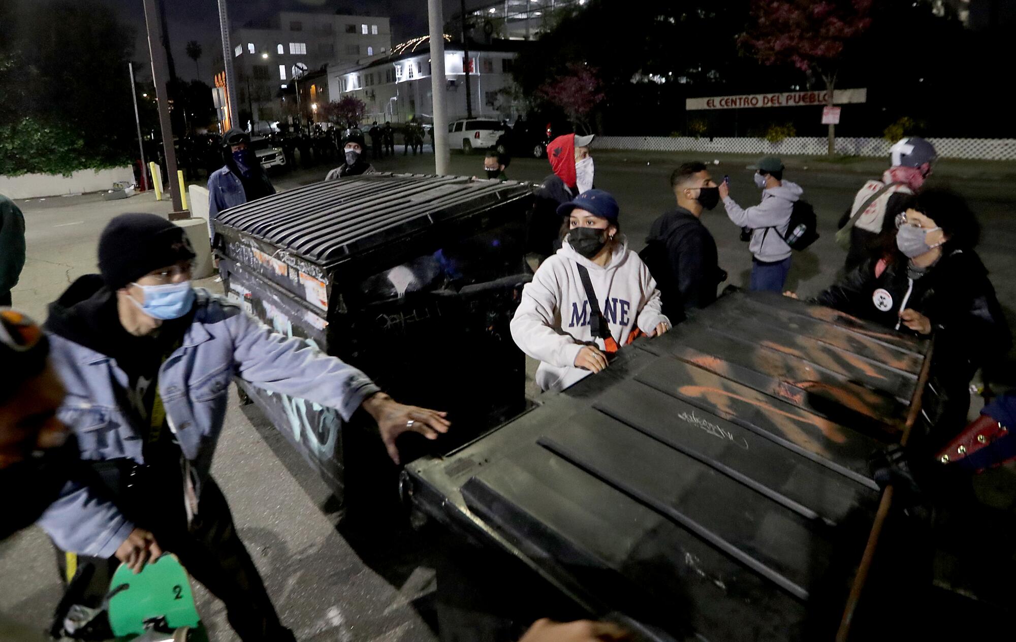 People line up dumpsters. 