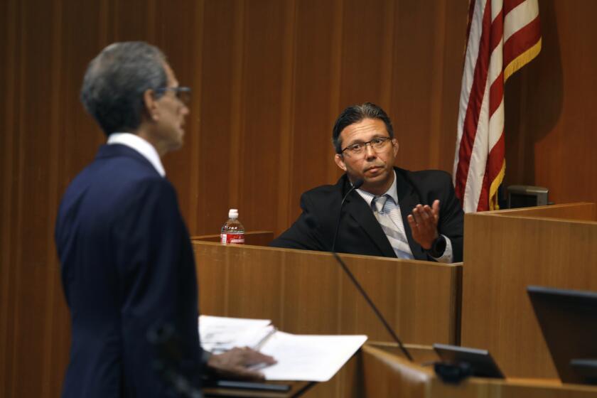 Los Angeles, California-Aug. 19, 2022-Sgt. Jefferson Chow, right, answers questions from Counsel Bert Deixler, left, as he testifies before the civilian oversight commission on gangs in the Los Angeles County Sheriff's Department on Aug19, 2022 at Loyola Marymount University Law, Advocacy Center, Robinson Courtroom, in downtown Los Angeles. (Carolyn Cole / Los Angeles Times)