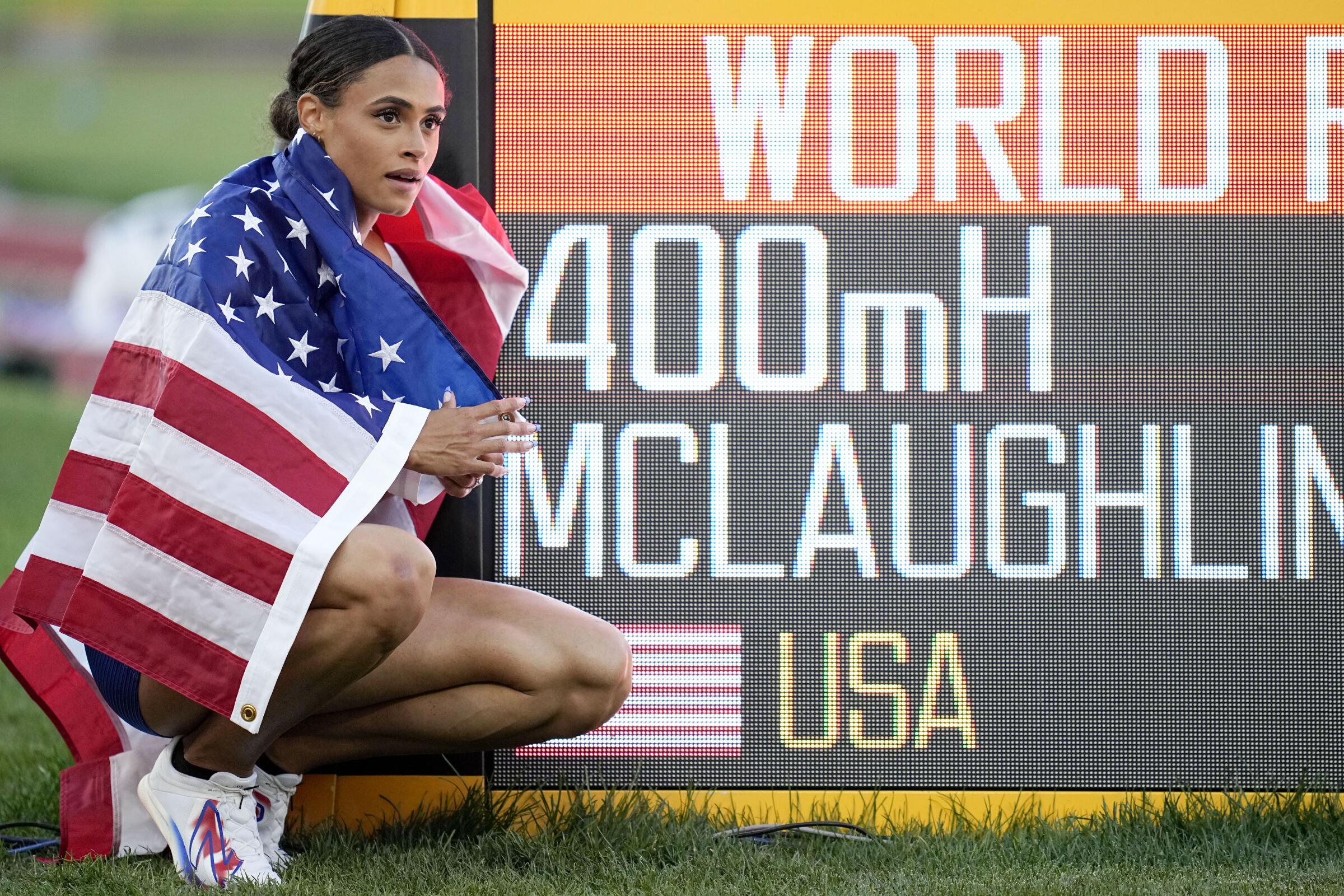 Sydney McLaughlin-Levrone beside a sign after winning the 400-meter hurdles at the 2022 World Athletics Championships.