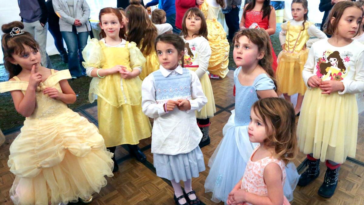 Young girls dressed as Belle from the Disney movie "Beauty and the Beast" have their costumes judged during the Beauty and the Beast Dance Ball at the Family Drive-In Theatre in Stephens City, Va., Sunday, March 19, 2017. The ball took place before the showing of the movie.