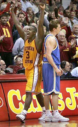 USC's Lodrick Stewart begins to celebrate a 71-68 victory over UCLA and Michael Roll on Sunday.