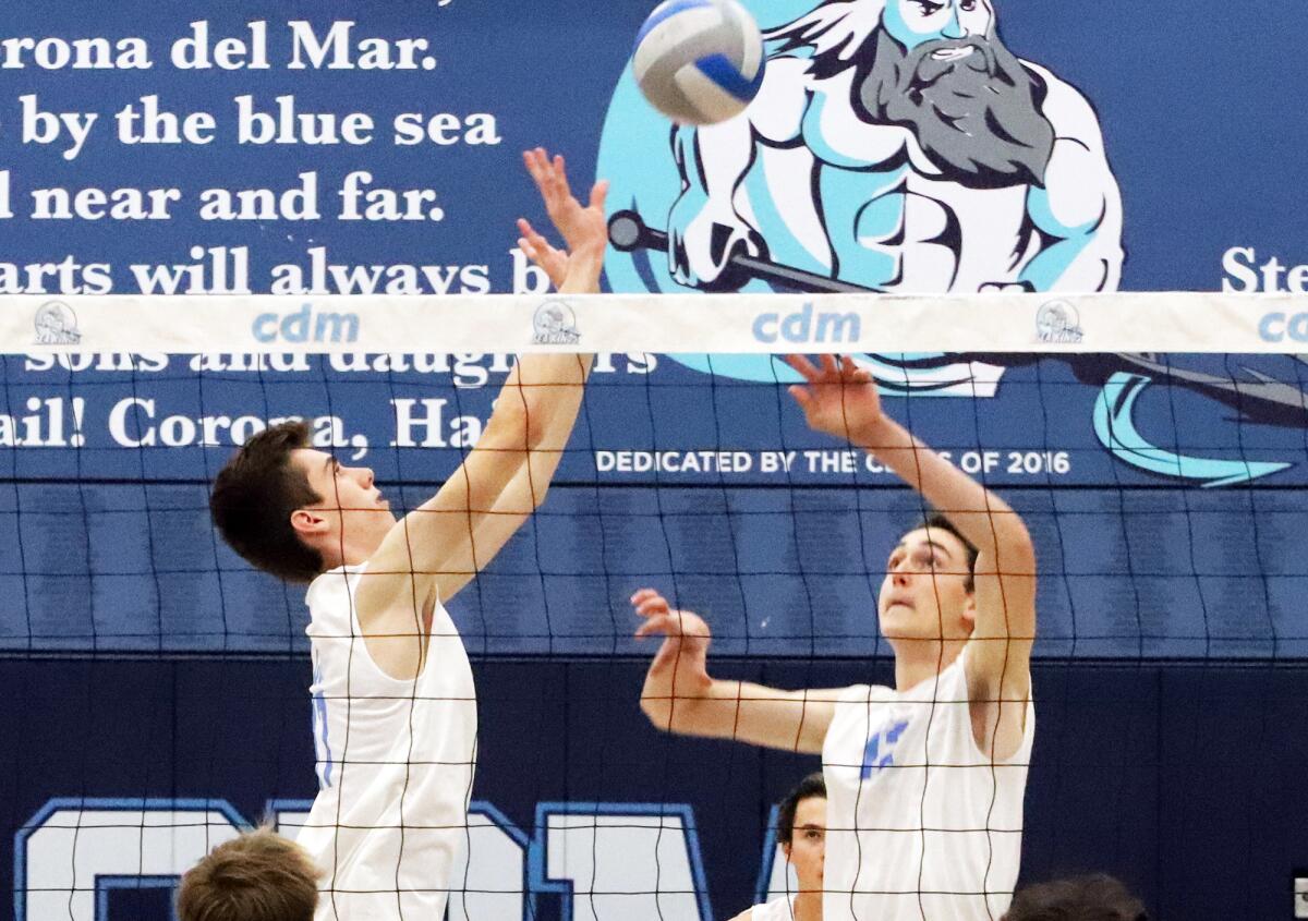 Corona del Mar's Ryan Gant (17) sets up Daniel Booker (12) in a CIF Division 1 boys' volleyball playoff match on Wednesday.