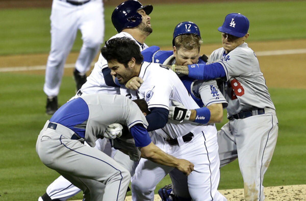 Padres left fielder Carlos Quentin grabs Dodgers pitcher Zack Greinke as other Dodgers and Padres arrives during the start of a brawl in the sixth inning Thursday night at Petco Park in San Diego.