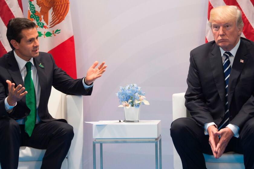 (FILES) This file photo taken on July 7, 2017 shows US President Donald Trump and Mexican President Enrique Pena Nieto holding a meeting on the sidelines of the G20 Summit in Hamburg, Germany. US President Donald Trump pressed Mexican President Enrique Pena Nieto to stop saying publicly that Mexico would not pay for his promised border wall, according to a transcript of their January conversation obtained by The Washington Post."You cannot say that to the press," Trump told Pena Nieto according to the transcript of the January 27 call published by the Post on Thursday."I have to have Mexico pay for the wall -- I have to," Trump said. "I have been talking about it for a two-year period." / AFP PHOTO / SAUL LOEBSAUL LOEB/AFP/Getty Images ** OUTS - ELSENT, FPG, CM - OUTS * NM, PH, VA if sourced by CT, LA or MoD **