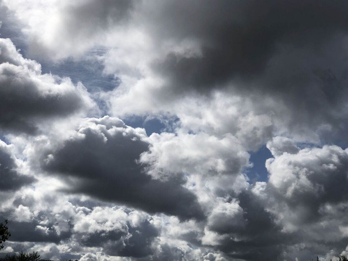 The rain clouds are moving out but the marine layer will stick around this weekend.