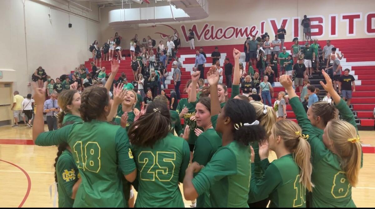 The Mira Costa girls' volleyball team celebrates after a victory.