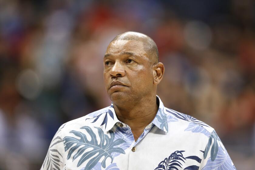 Clippers coach Doc Rivers watches his team play a preseason game against the Rockets.