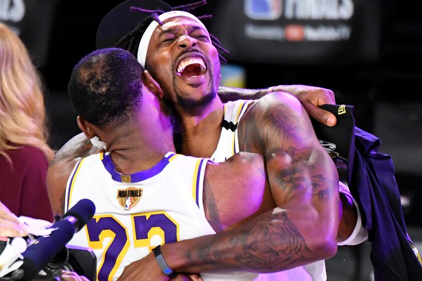 Dwight Howard closes his eyes as he embraces LeBron James as they celebrate after the Lakers' 2020 NBA championship.