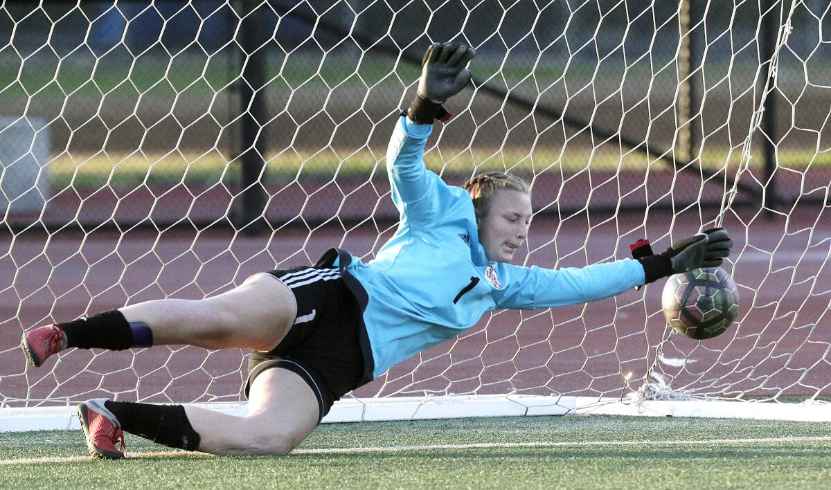 Burroughs' goalie Kaylin Casper guessed correctly but the ball, shot on an Arcadia penalty kick, gets to the goal beyond her outstretched hand in a Pacific League girls' soccer game at Arcadia High School in Arcadia on Tuesday, January 28, 2020.