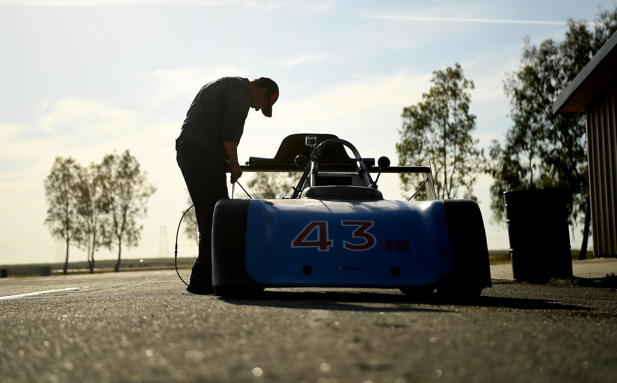 James Kuhns, 78, who has been racing since 1968, prepares his car before a race at Buttonwillow Raceway in Buttonwillow, Calif., on Saturday.
