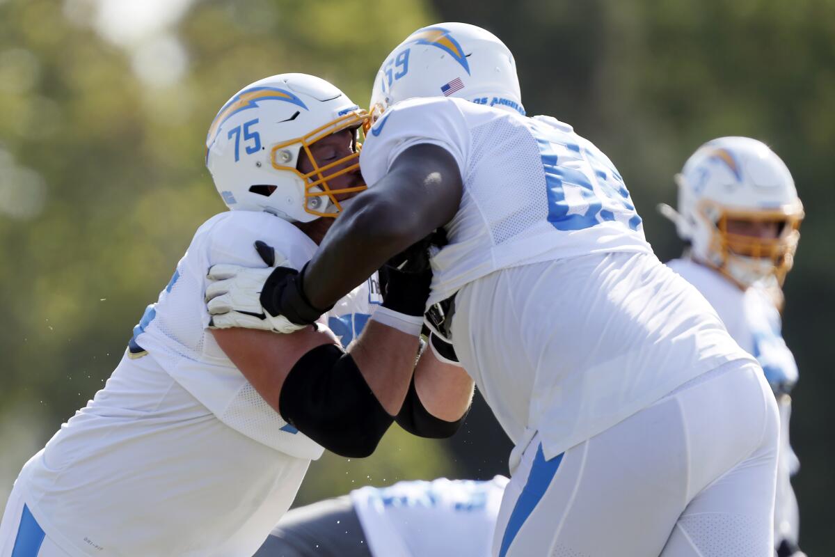 Chargers offensive tackle Bryan Bulaga works on a drill with offensive tackle Darius Harper.