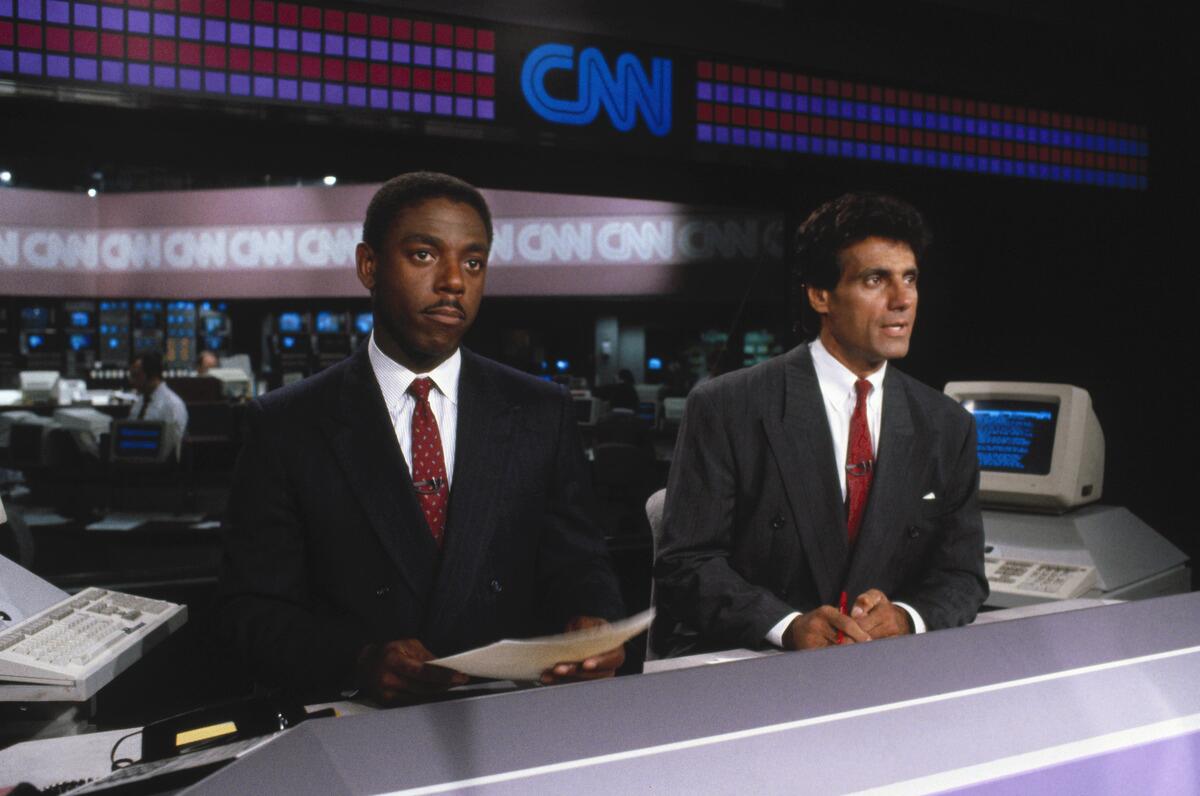 Fred Hickman, left, and Nick Charles on the set of CNN's "Sports Tonight" in 1980.