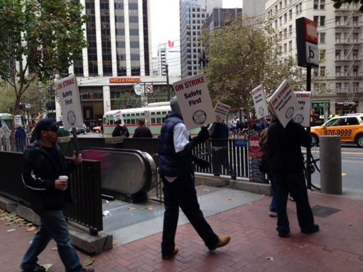 Members of Amalgamated Transit Union Local 1555 picket at San Francisco's Embarcadero station on Monday. They are emphasizing safety in the wake of two worker deaths.