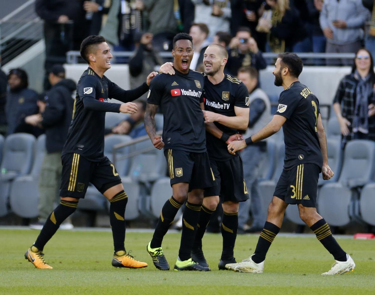 Los Angeles FC midfielder Mark-Anthony Kaye, second from left, of Canada, celebrates his goal with teammates in the first half of an MLS soccer match against Portland Timbers in Los Angeles, Sunday, March 10, 2019. (AP Photo/Ringo H.W. Chiu)