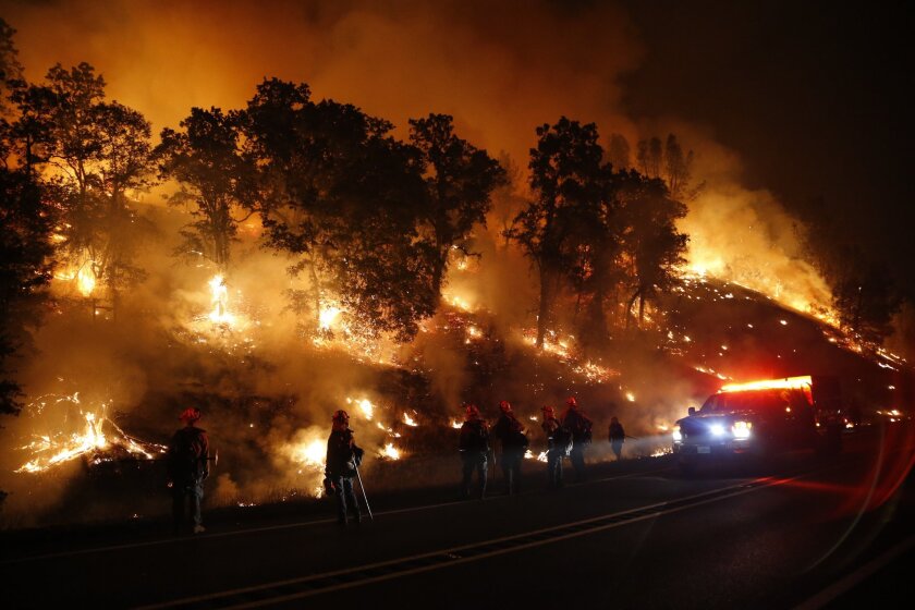 Firefighters monitor a backfire Sept. 13 as they battle the Valley fire near Middletown, Calif.