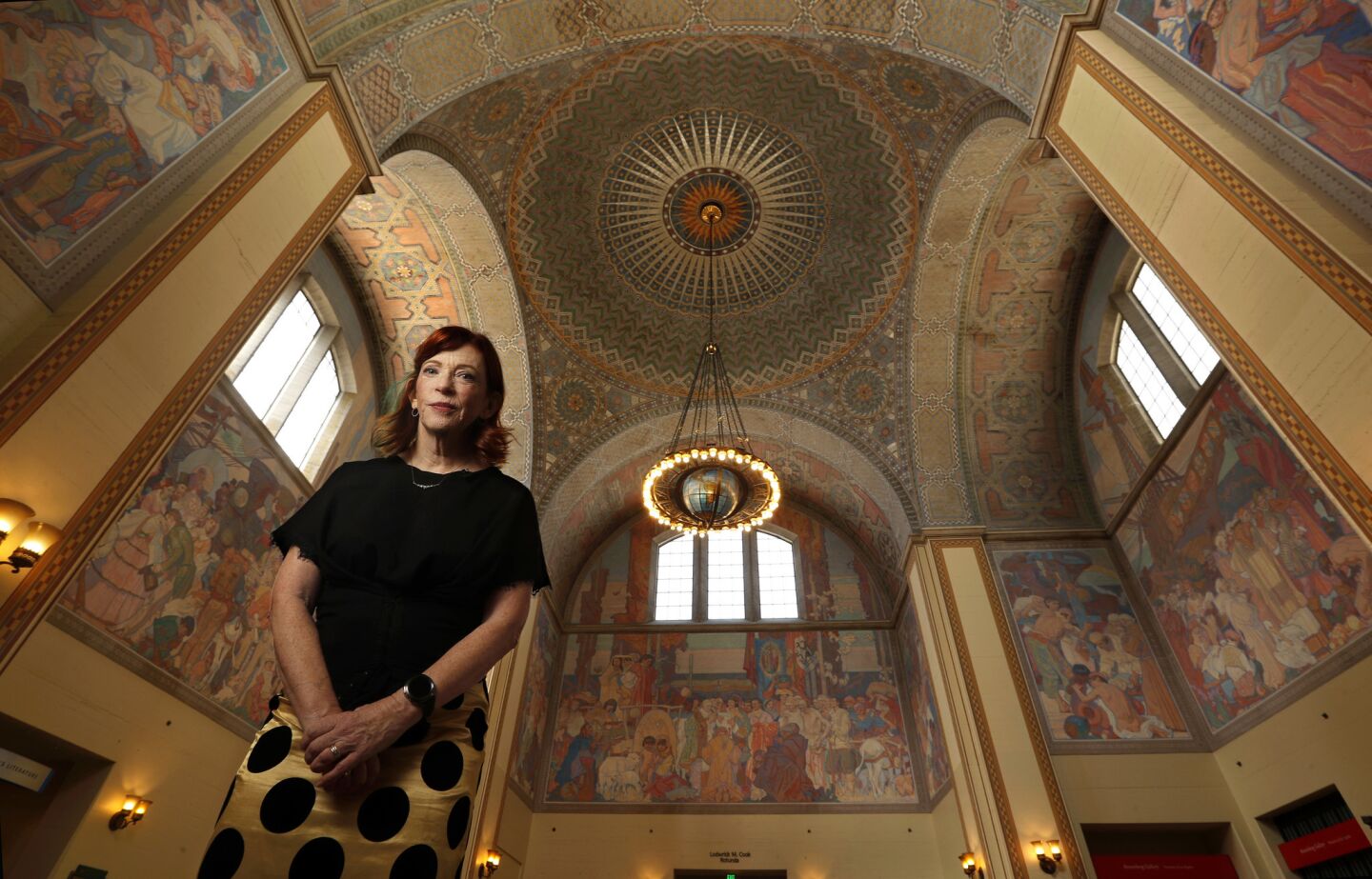 Susan Orlean visits the Central Library's second floor, with the rotunda above her.