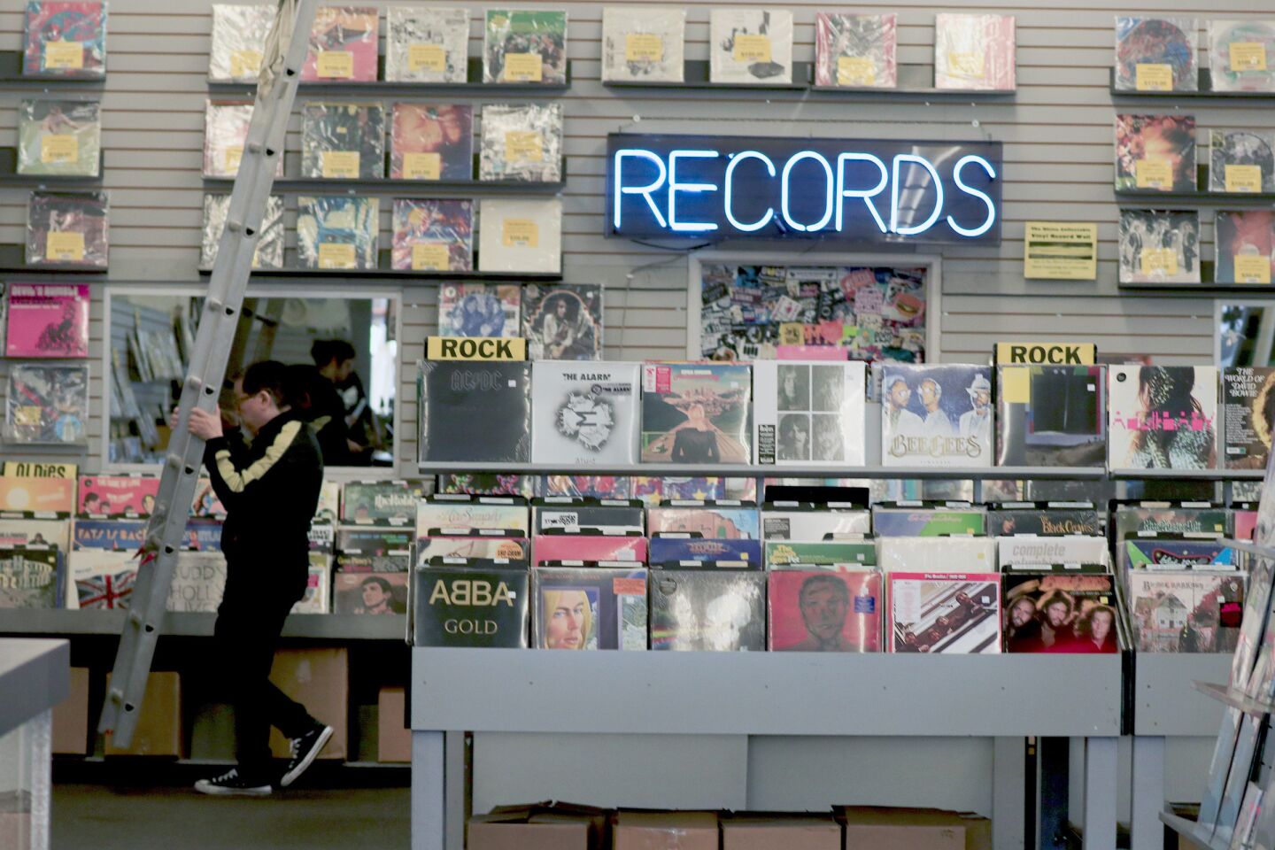 It takes a ladder to reach some of the records and posters on display at Rhino Records in Claremont Village.