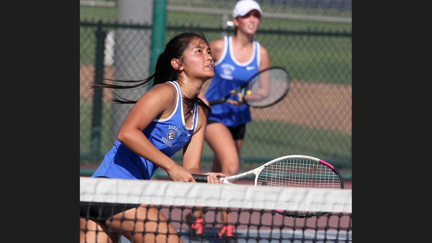 Burbank's Kryastal Hirahara and teammate Elza Vardanyan move to be in position to return a shot by Crescenta Valley in a Pacific League girls' tennis match at Burbank High School on Thursday, September 7, 2017.