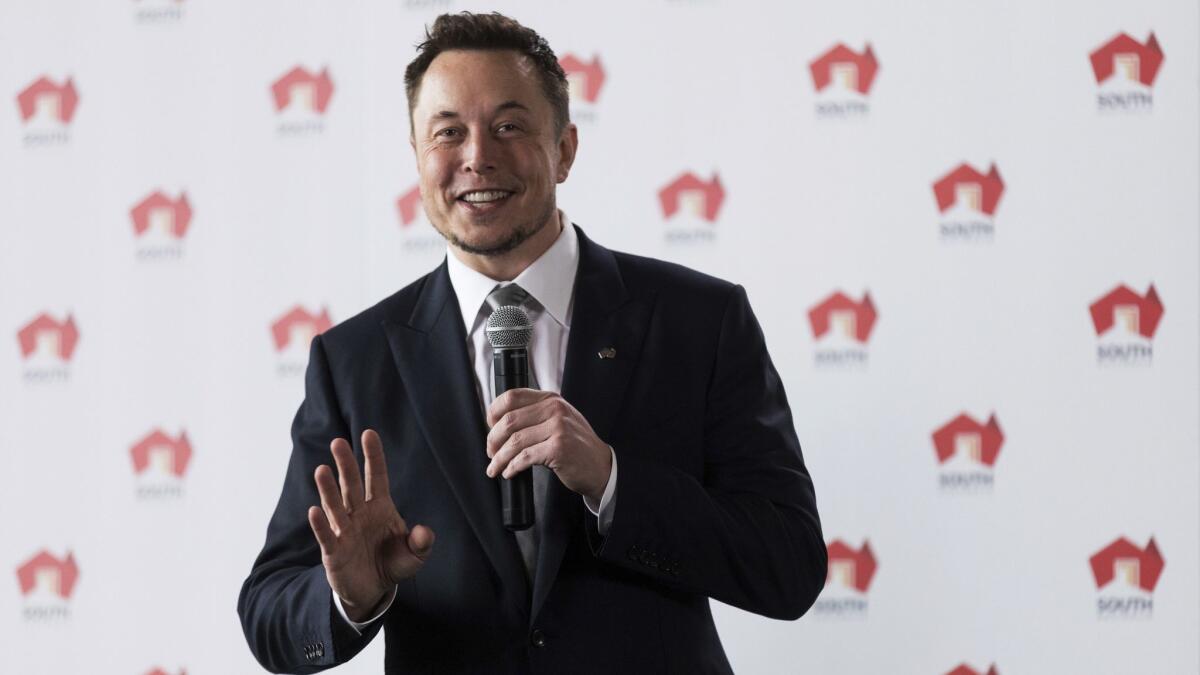 Elon Musk speaks at an event in July, days after forecasting an annual production rate of 240,000 Model 3s by the end of December. Soon after, Tesla would issue $1.8 billion in unsecured bonds.