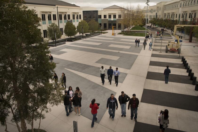Employees walk the grounds at Facebook's Menlo Park, Calif., headquarters in 2012.