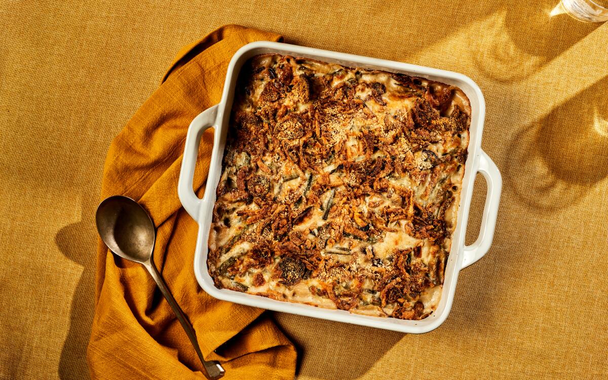 Tender green beans and mushrooms are baked in a creamy sauce under a crust of fried onions and Parmesan cheese.