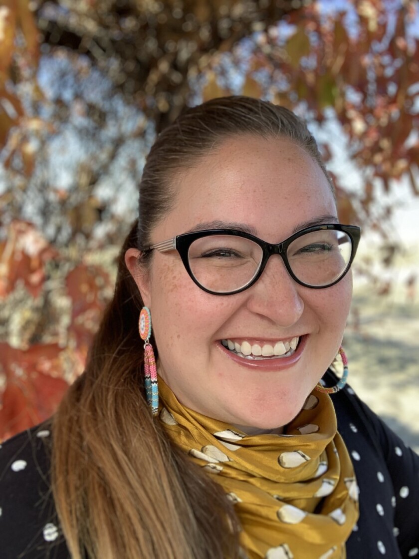 Molina Parker smiles in a B.Yellowtail elk tooth silk scarf.