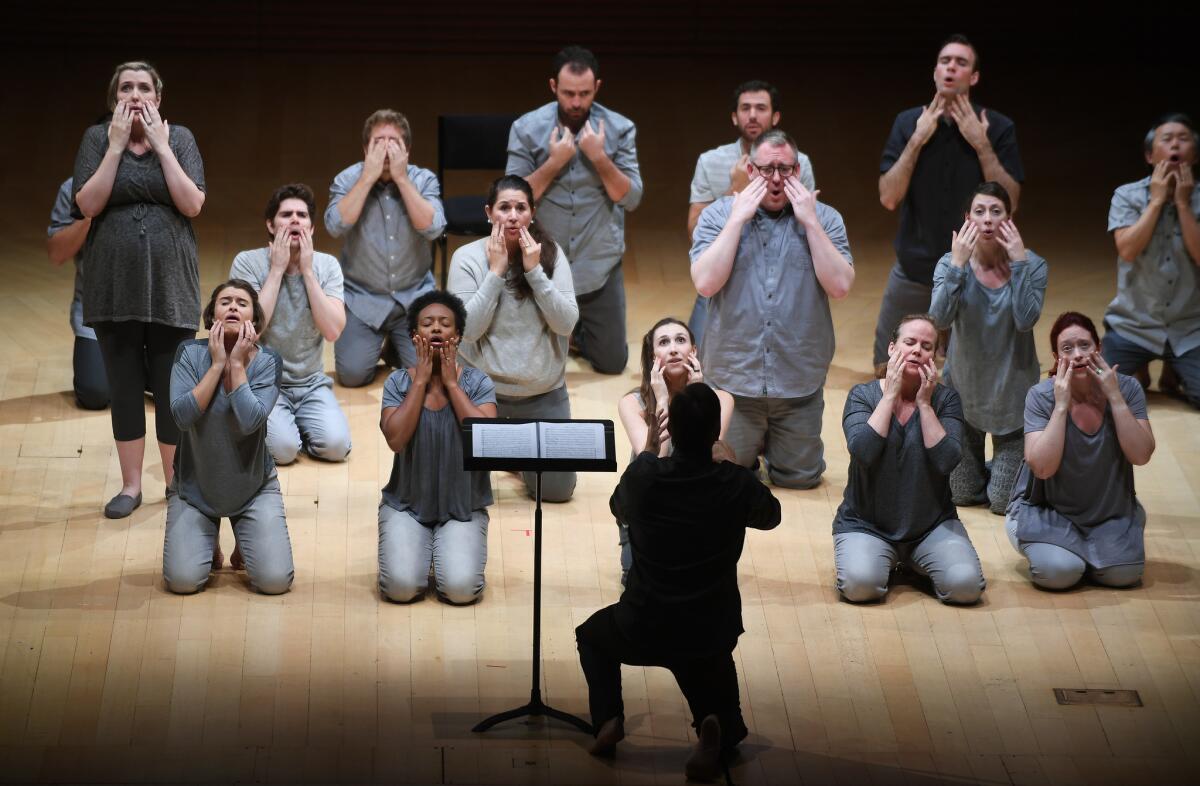 Members of Los Angeles Master Chorale kneel as though they were Noh players during a recent performance of Orlando di Lasso's "Lagrime di San Pietro."