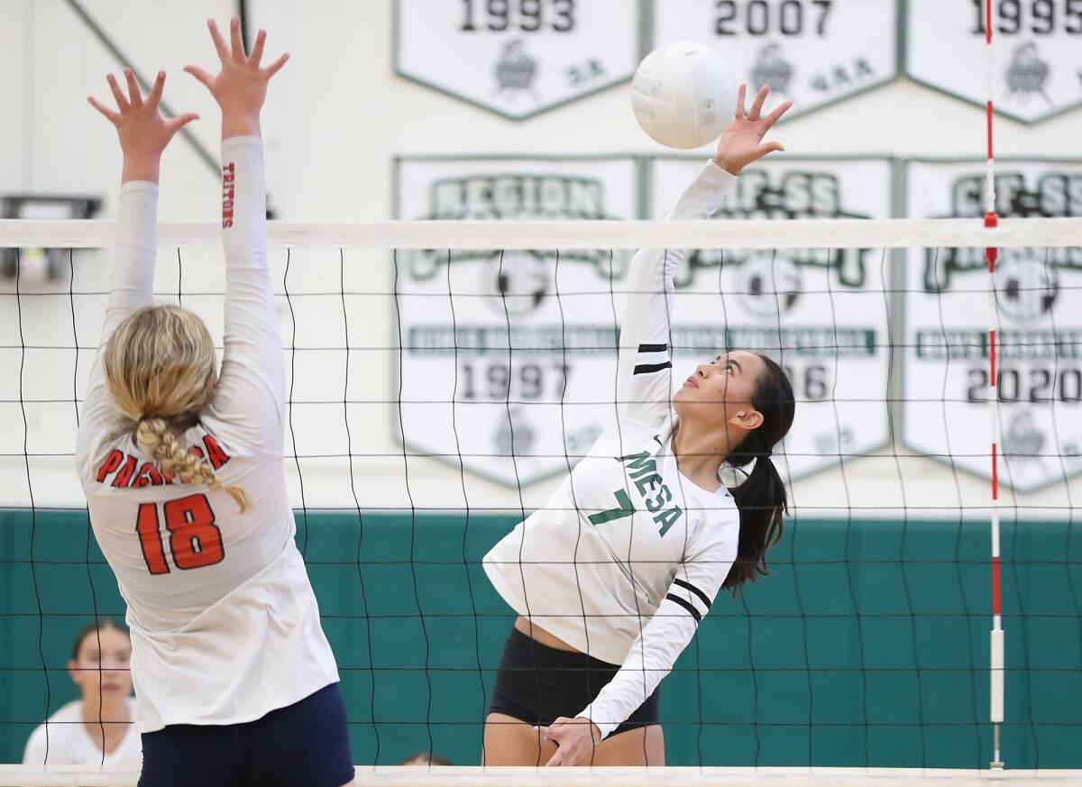 Costa Mesa's Aubrey Spallone (7) reaches back to put a kill away against Pacifica Christian on Thursday.