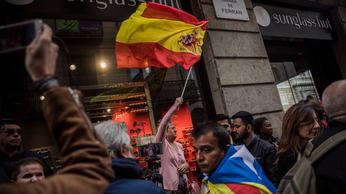 A woman waves a Spanish flag during a pro-Catalan independence protest in Barcelona, Spain, on Wednesday.